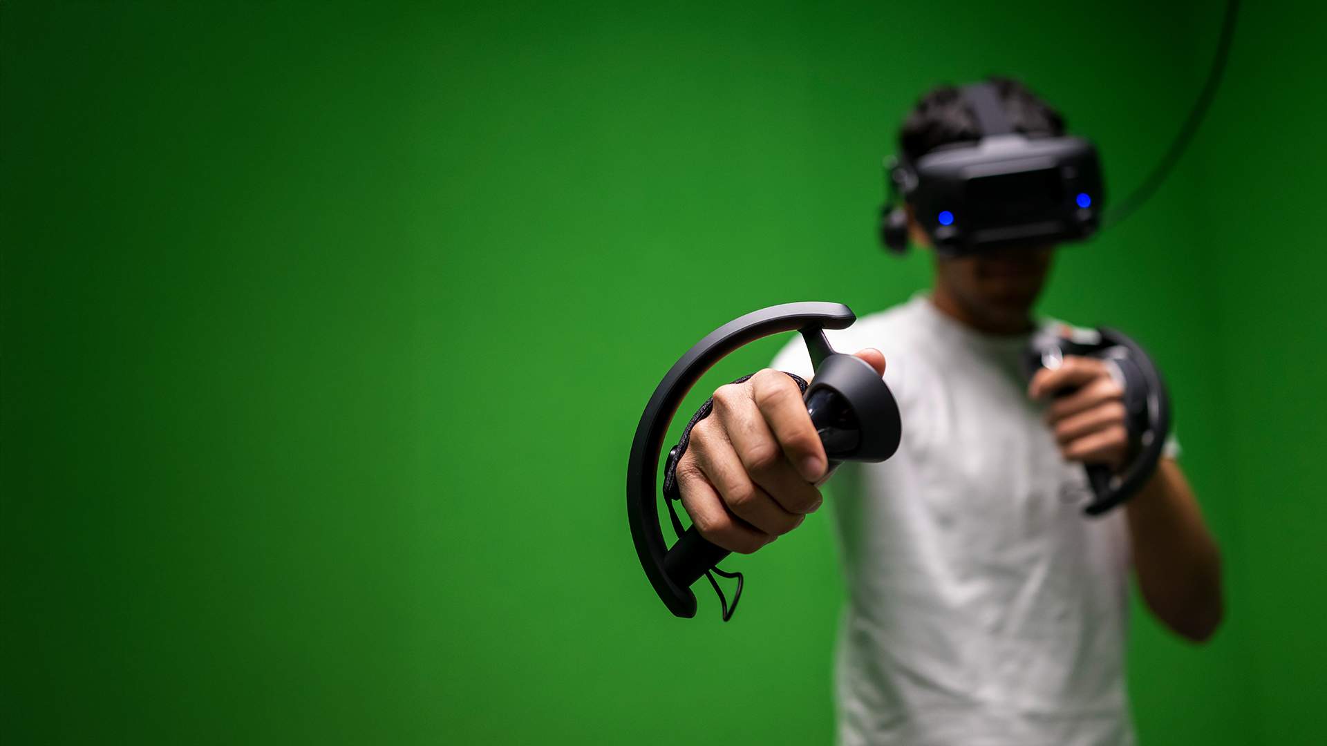 A student holding virtual reality googles and handset