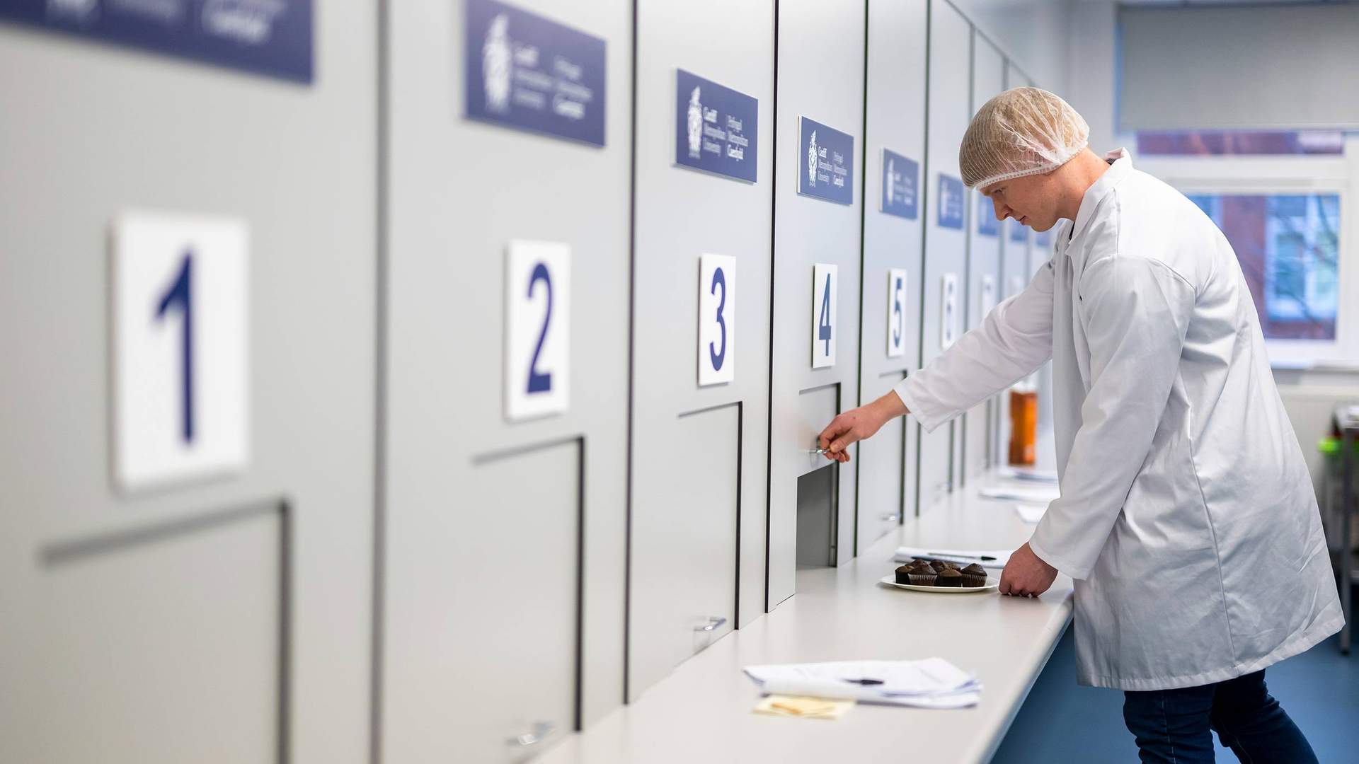 Student opening sliding panel in Food Industry Centre evaluation suite