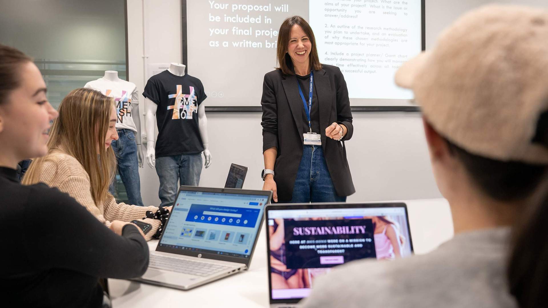 A person stands in front of a class of students.