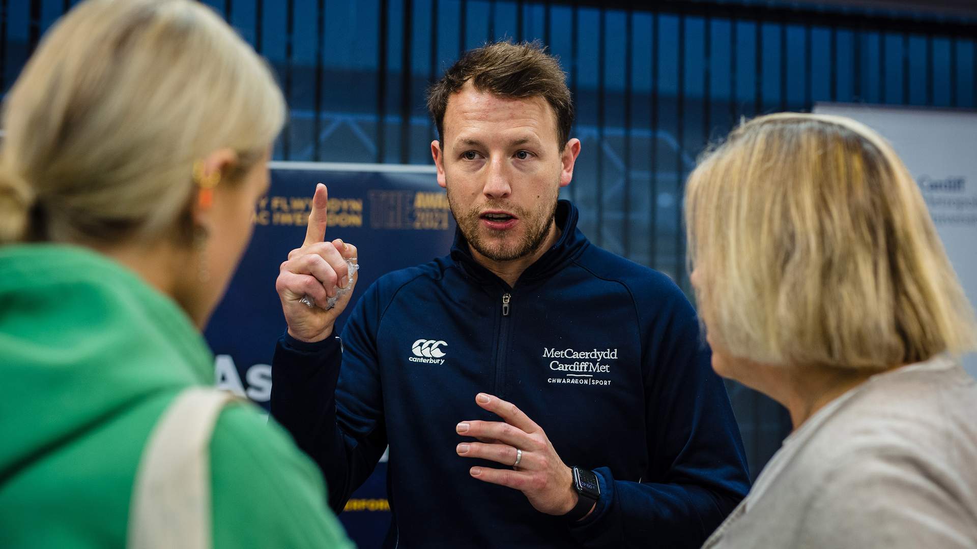 Met Sport Representative talking to 2 females, explaining what the facilities have to offer