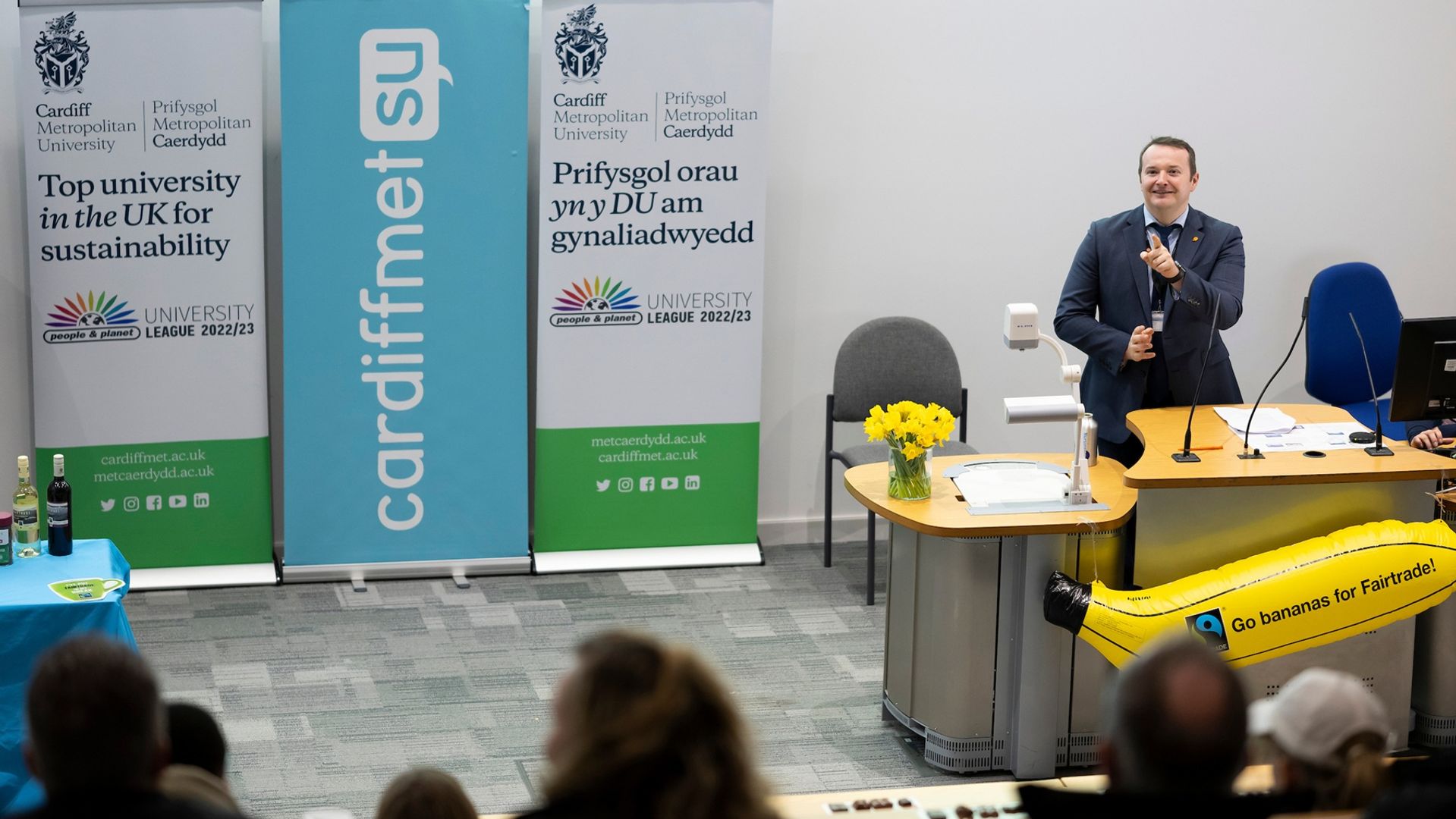 A member of Cardiff Met staff hosts a sustainability meeting in a lecture hall
