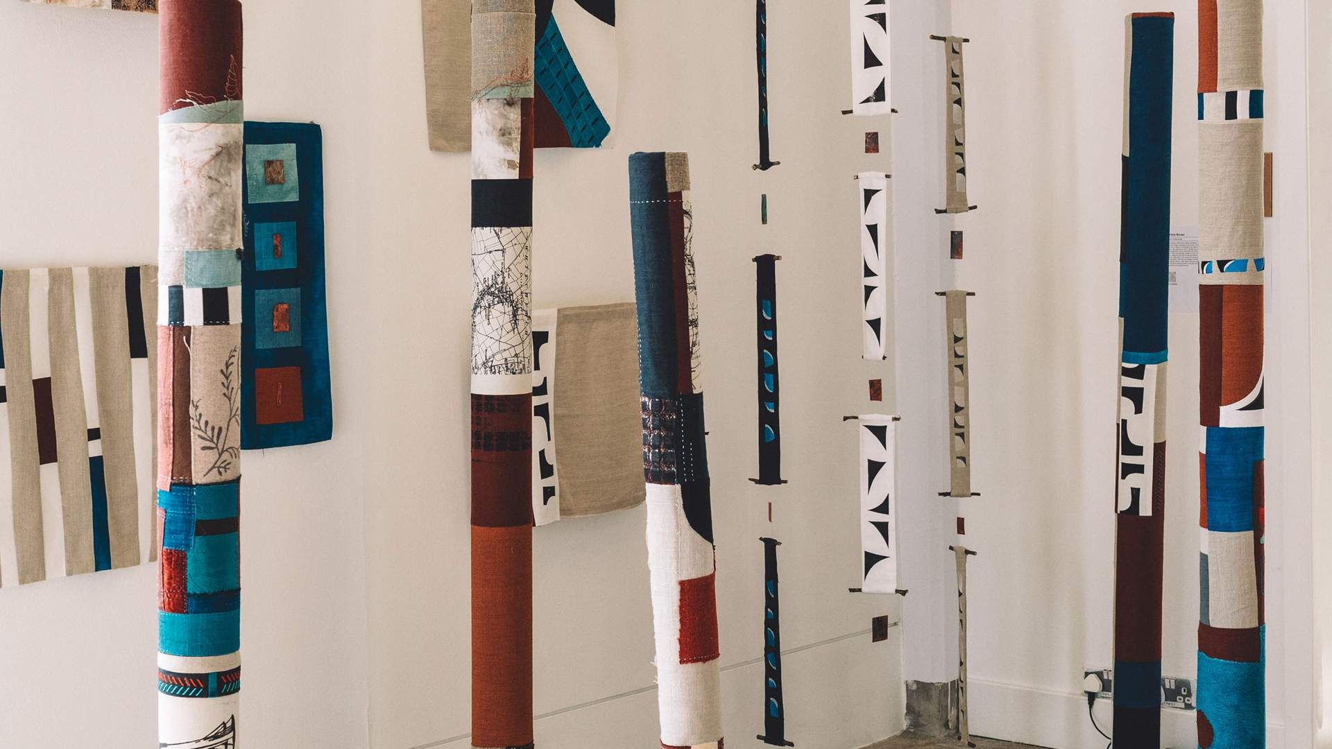 A collection of textile columns in an open art space