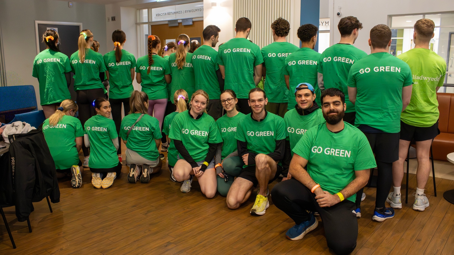 A large group of Go Green Week volunteers in matching green 'Go Green' t-shirts