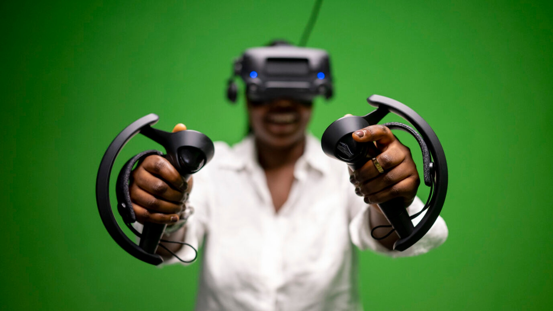 Student wearing virtual headset and holding controllers