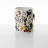 Floral porcelain vessel on a reflective white table