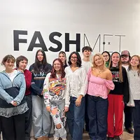 Fashion week event showcasing designs at the Met Fashion and Design, featuring models and vibrant displays.