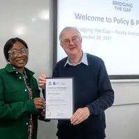 Former First Minister Mark Drakeford awards a certificate to an attendee of the Ready Access Programme at Cardiff Met