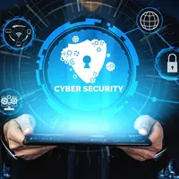 An individual holding an electronic tablet that is displaying graphic visuals on the theme of cyber security