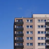 A tall building set against a clear blue sky.