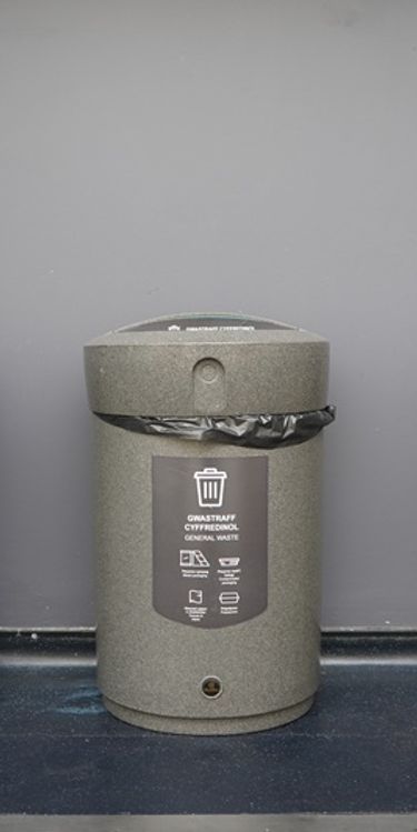 Three colour-coded waste and recycling bins