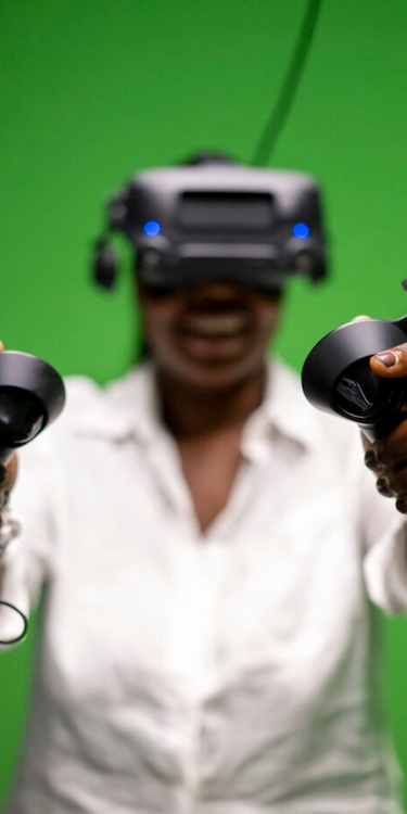 Student wearing virtual headset and holding controllers