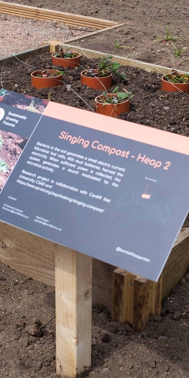 Information sign in front of a plant bed