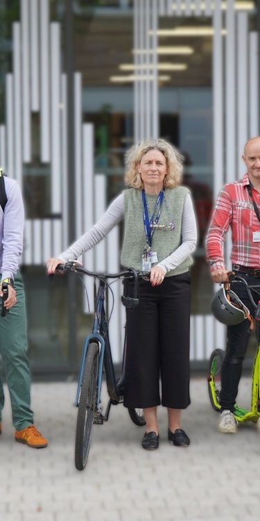 A group of Cardiff Met staff beside their bicycles