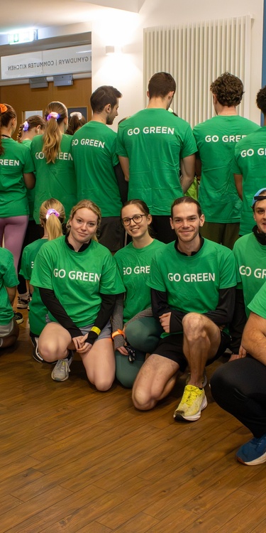 A large group of Go Green Week volunteers in matching green 'Go Green' t-shirts