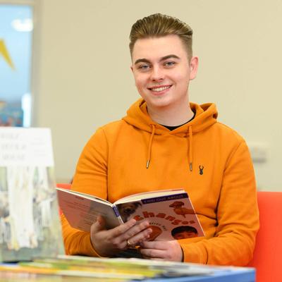 Student with primary school textbooks