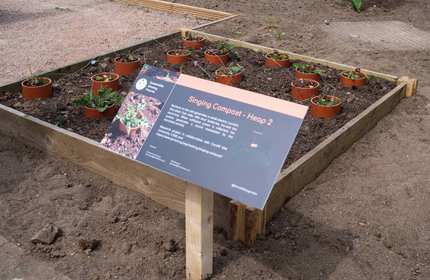 Information sign in front of a plant bed