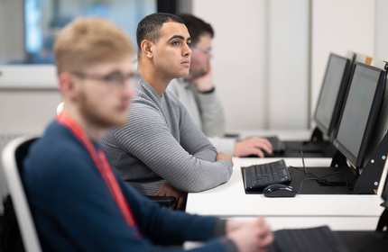 Group of students using computer workstations