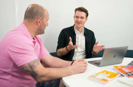 Postgraduate student sat at table
