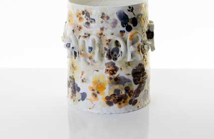 Floral porcelain vessel on a reflective white table