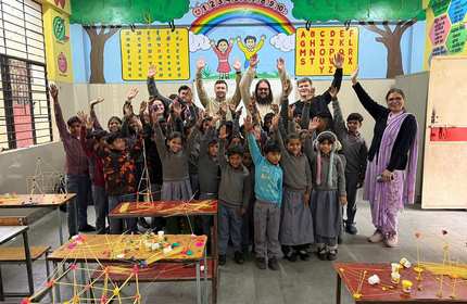 A diverse group of children and adults happily posing for a photo, showcasing smiles and camaraderie.