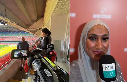 A woman wearing a headscarf interviews an individual in the stands of a sport stadium. A woman wearing a headscarf takes a selfie while holding a microphone close their their face.