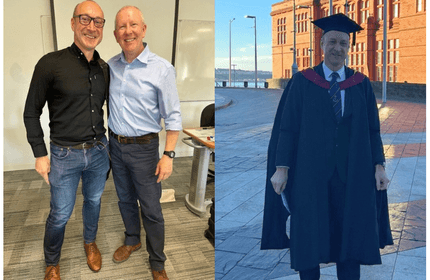 20Twenty Programme student stands with a colleague and in graduation cap and gow