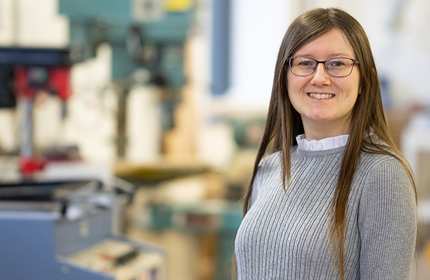Headshot of Jess Hornby in front of an industrial workshop