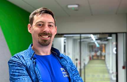 Student headshot in a Cardiff Met campus hallway