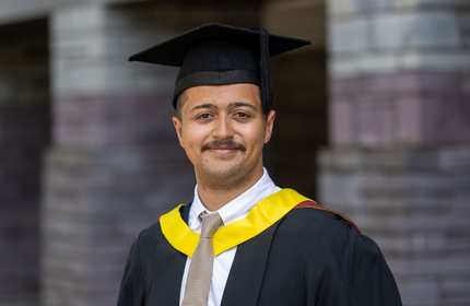 Headshot of Aaron Pearce in graduation cap and gown