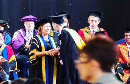 Alexander Nash shakes hands with the Vice-Chancellor of Cardiff Met University during a graduation ceremony