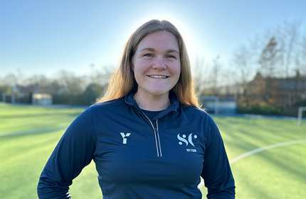 Headshot of Emily Brightling on a sports pitch