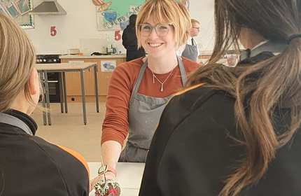 Georgina Allen faces to students she is teaching in a classroom