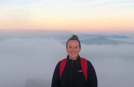 Cerys Davies above the cloud range on a tall mountain