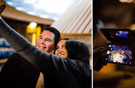 A couple takes a selfie, smiling happily together indoors. On the right, a close-up shows someone holding a mobile phone capturing a photo of a round, lit-up interior space.