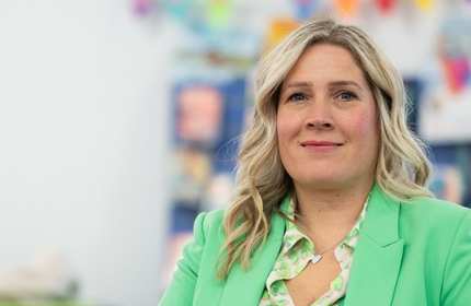 A person wearing a bright green jacket.