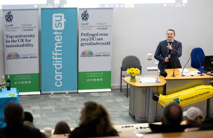 A member of Cardiff Met staff hosts a sustainability meeting in a lecture hall
