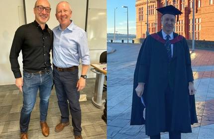 20Twenty Programme student stands with a colleague and in graduation cap and gown