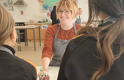 Georgina Allen faces to students she is teaching in a classroom