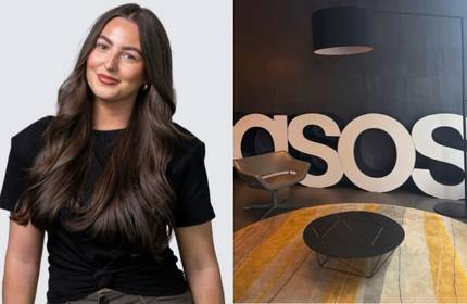 A woman in a black top in front of a white background. A large sign reading 'Asos' in an office common area