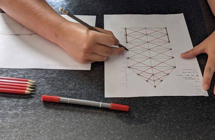 Close-up of an architectural plan being sketched by hand.