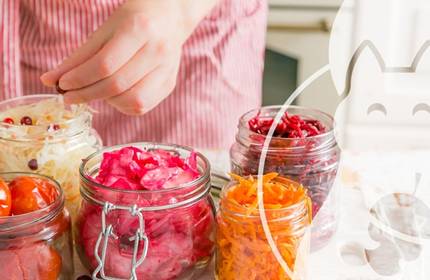 A selection of pickled fruits and vegetable in various size jars