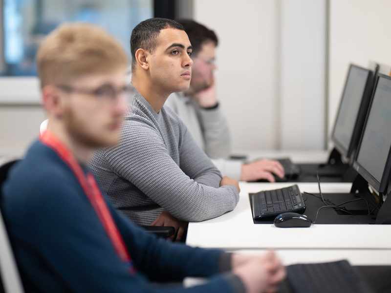 Group of students using computer workstations