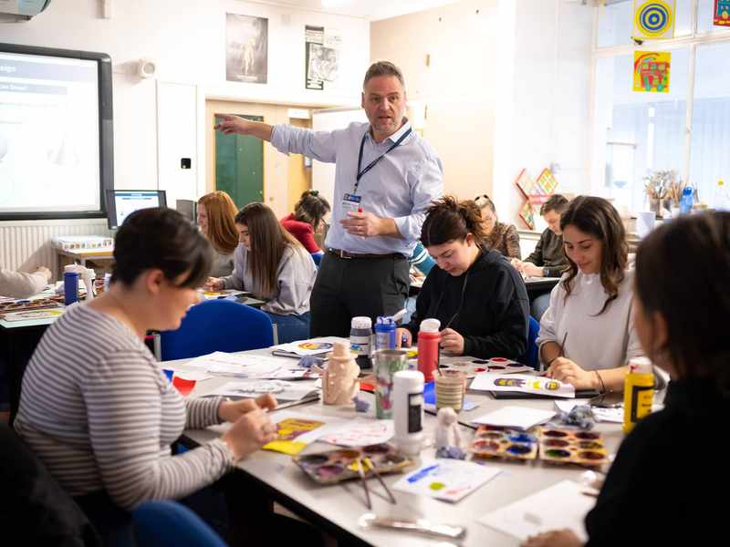 Lecturer with student teachers in art and design class