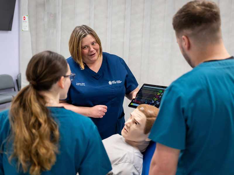Lecturer and students with manikin in Allied Clinical Health Hub