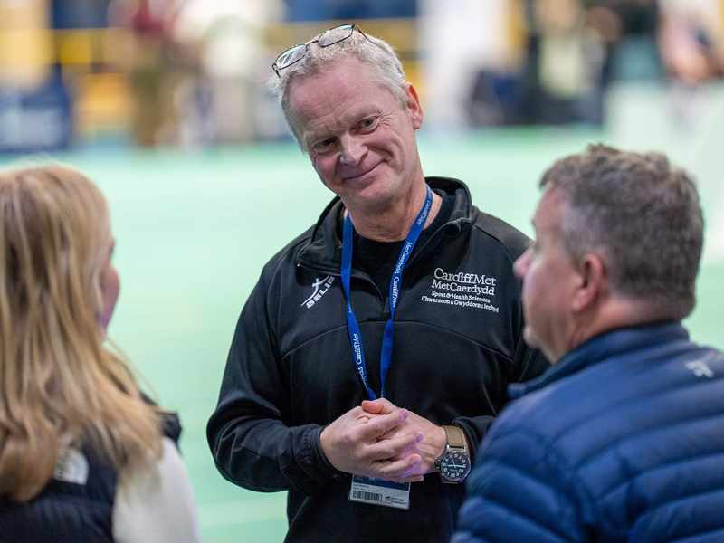 A lecturer speaking to visitors at an Open Day Information Fair.