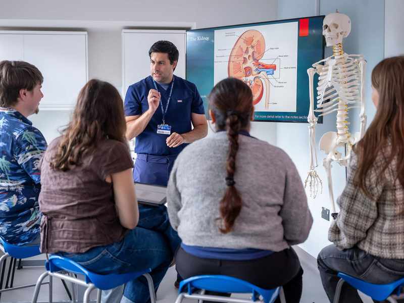 Nursing lecturer with group of students