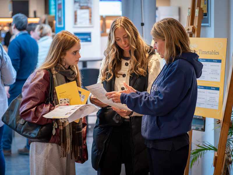 Cardiff Met staff with visitors at an Open Day Information Fair.