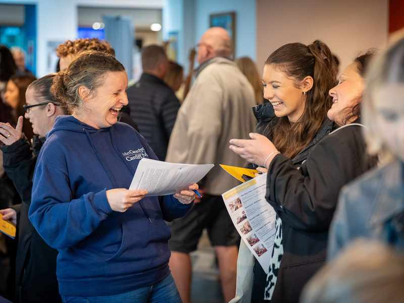 Cardiff Met staff with visitors at an Open Day Information Fair.
