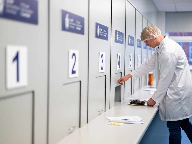 Student opening sliding panel in Food Industry Centre evaluation suite