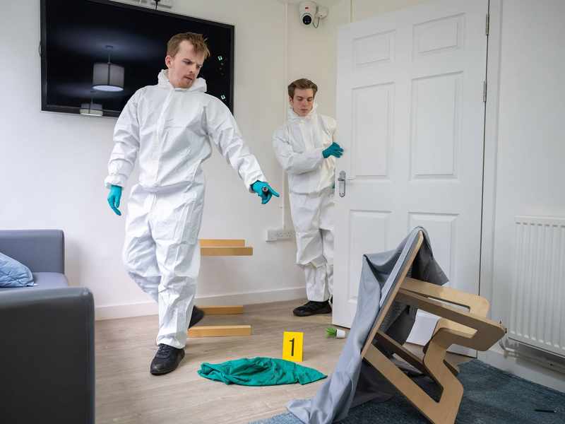 Students entering simulated crime scene in Crime House